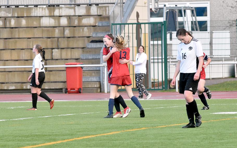 Lakenheath's Annabelle Herring, facing, and Heidi Amberson hug after Herring' 74th-minute, match-winning goal against Stuttgart on Friday evening at Kaisersalutern High School in Kaiserslautern, Germany. At right is the Panthers' Gracie Self.