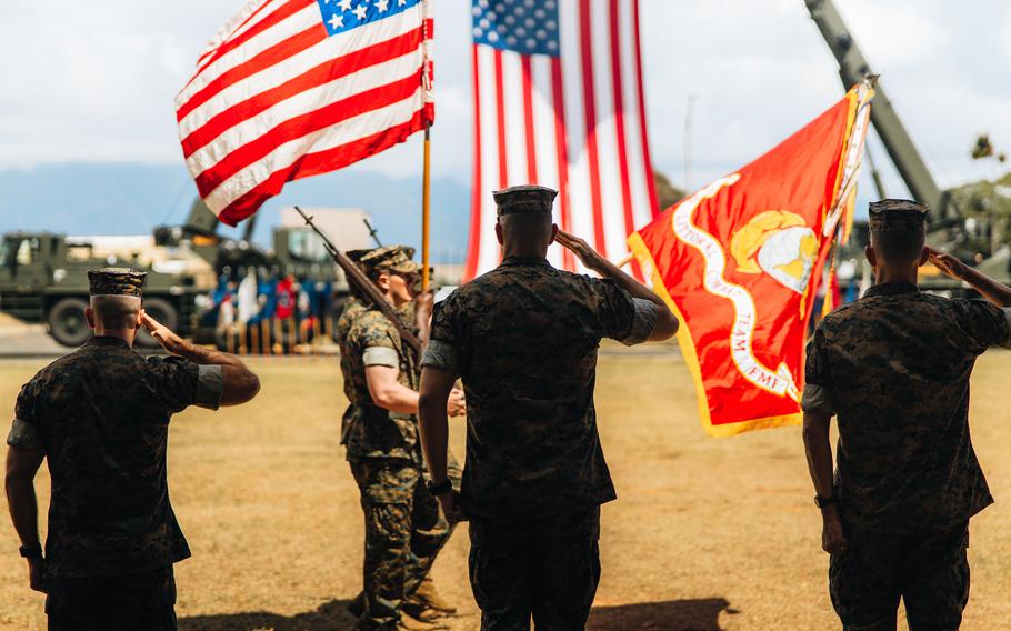 From left to right, Lt. Col. Andrew Gourgoumis, Lt. Col. Adam R. Sacchetti, commander of 1st Battalion, 3rd Marines, and Col. Timothy S. Brady Jr, commander of 3rd Marine Littoral Regiment, salute during the battalion’s redesignation ceremony at Marine Corps Base Hawaii, June 23, 2022. 