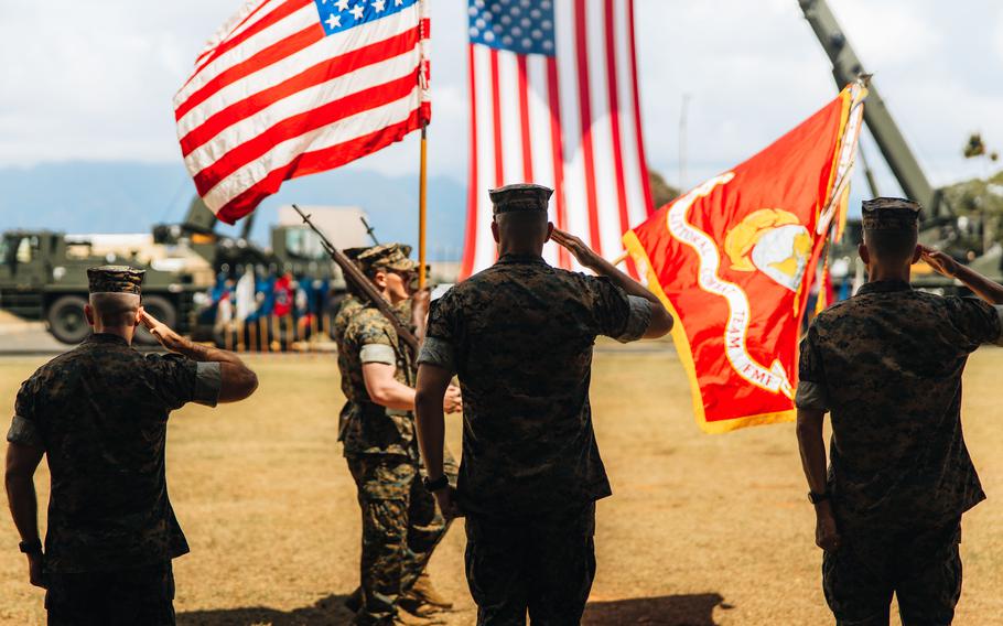 From left to right, Lt. Col. Andrew Gourgoumis, Lt. Col. Adam R. Sacchetti, commander of 1st Battalion, 3rd Marines, and Col. Timothy S. Brady Jr, commander of 3rd Marine Littoral Regiment, salute during the battalion’s redesignation ceremony at Marine Corps Base Hawaii, June 23, 2022. 