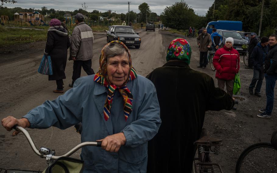 Villagers collect humanitarian aid in Verbivka, which Ukrainian forces retook last week. The sudden silence of no shelling is eerie, residents in the region said.