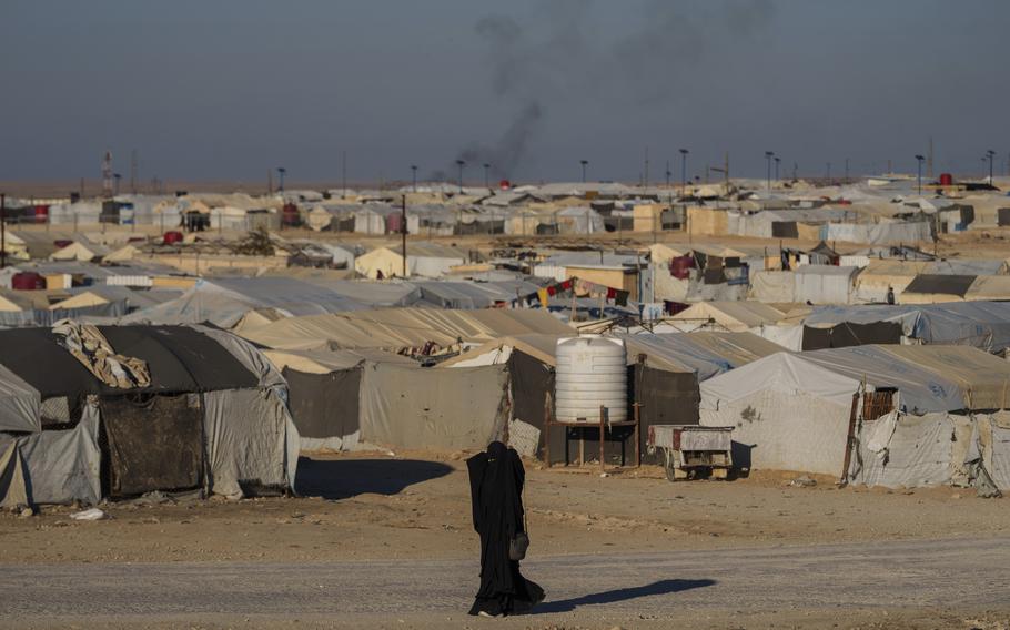 A woman walks in the al-Hol camp in northeastern Syria’s Hasakeh province