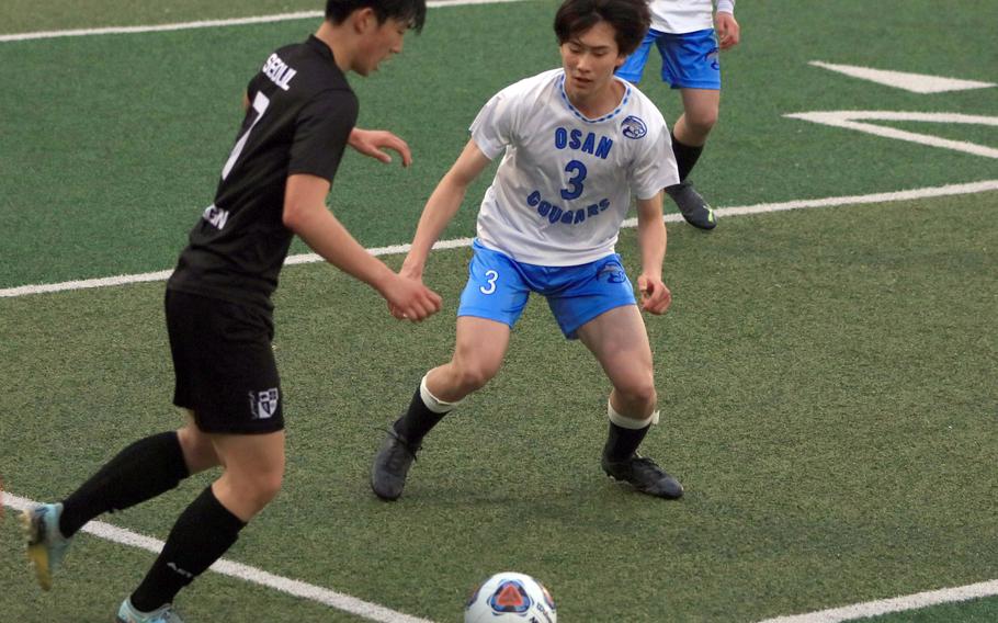 Seoul Foreign's Inwoo Song readies to kick the ball against Osan's Ben Plouff during Wednesday's Korea boys socceer match. The Crusaders won 10-0.
