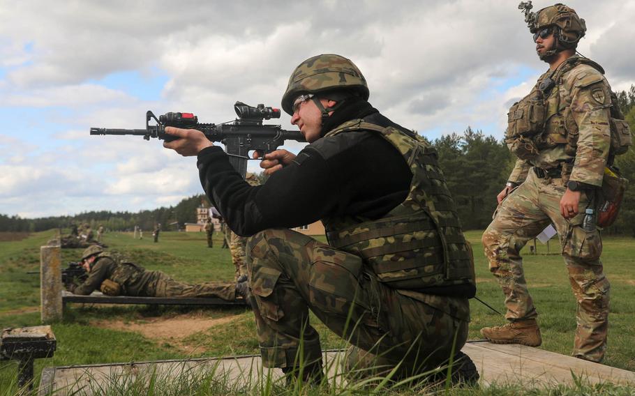 U.S. Army Sgt. Brandon Allen from the 3rd Infantry Division, with NATO’s enhanced Forward Presence Battle Group Poland, coaches a Polish service member on the M4A1 carbine rifle at Bemowo Piskie Training Area, Poland, April 15, 2024.