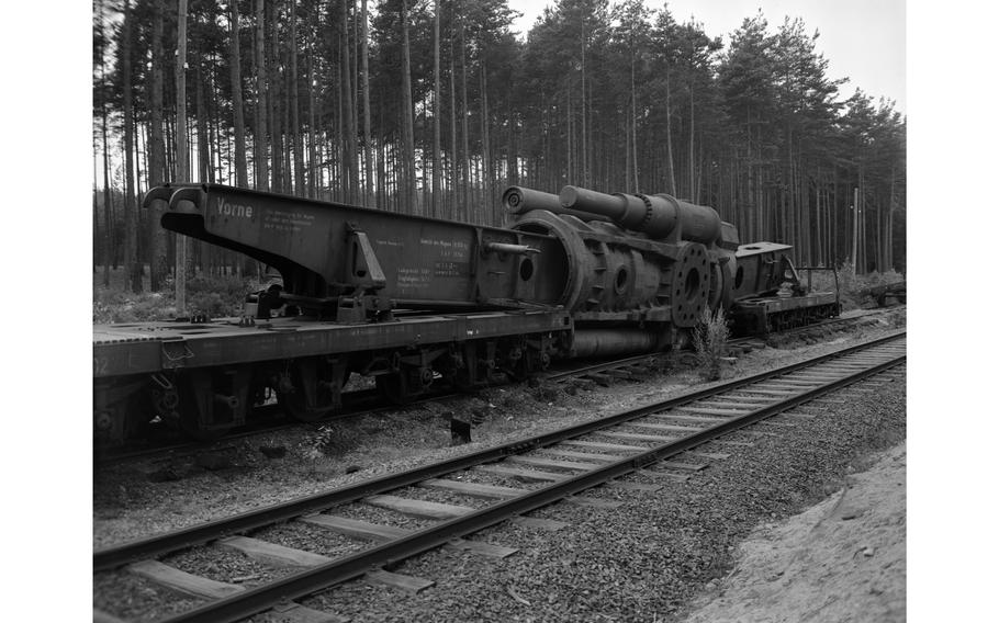 A massive Nazi Germany-produced railway gun is being disassembled in the woods near Grafenwöhr, Germany, by American forces in July 1949. The loading time for one of the 7-ton shells was about 45 minutes. 