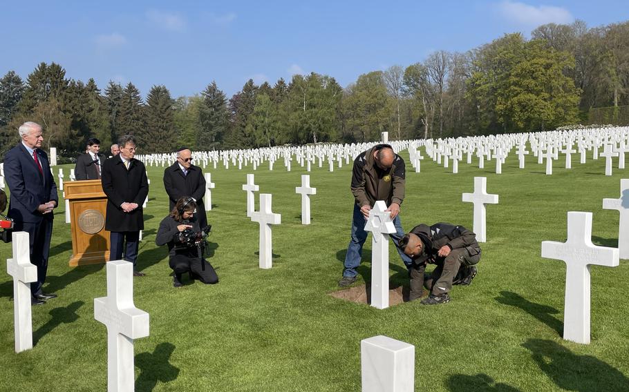 Workers place a Jewish headstone during a grave marker replacement ceremony at the Luxembourg-American Cemetery in Hamm, Luxembourg, on April 27, 2022. The ceremony was held by Operation Benjamin, an organization working to preserve the memories of Jewish American soldiers who died defending Europe in World War II.
