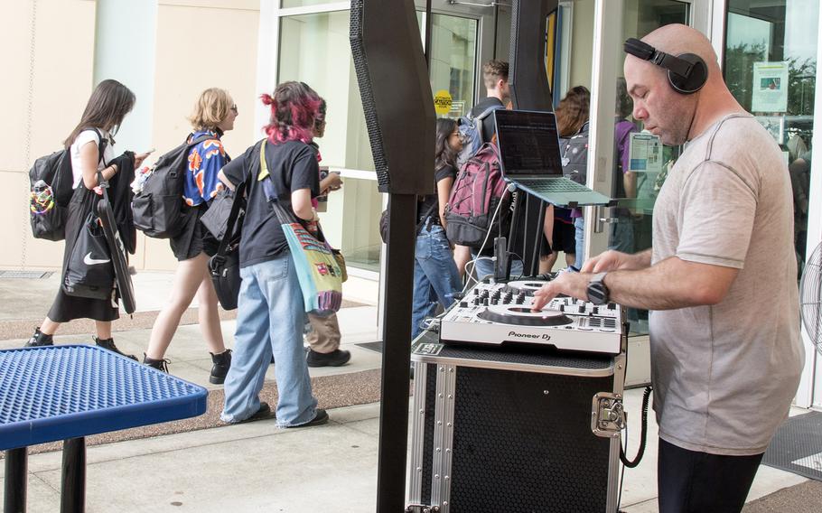 DJ Darrick D, also known as Lt. Col. Darrick Duran, plays "Lovely Day" by Bill Withers on the first day of classes at Yokota Air Base, Japan, Aug. 21, 2023.