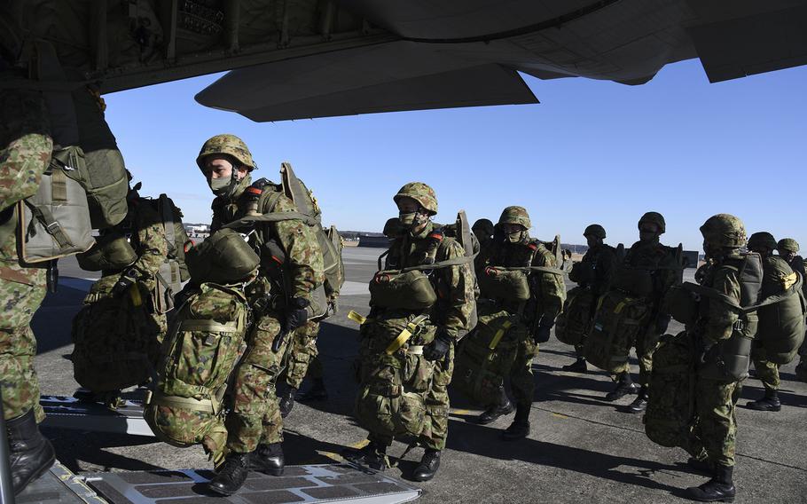 Japan Ground Self-Defense Force troops board an Air Force C-130J Super Hercules at Yokota Air Base, Japan, Thursday, Jan. 13, 2022.