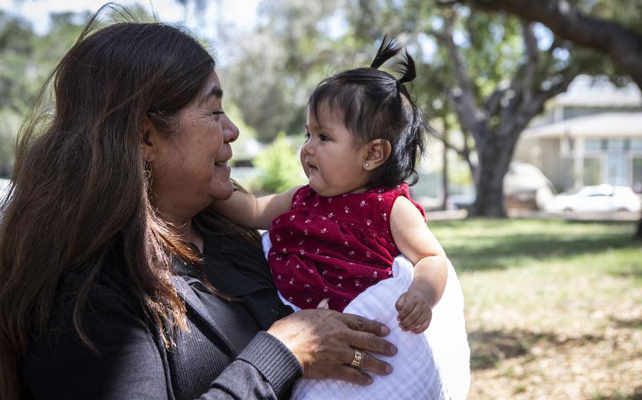 At the Santa Barbara party, Juana Flores holds Evelyn, the daughter of her son Caesar, who is serving with the U.S. Air Force in Turkey. 