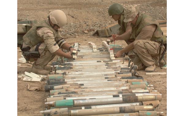 HED: Ready to blow, 2002

Kandahar, Afghanistan, Feb. 25, 2002: Explosive ordnance experts attach explosives to Soviet rockets for the purpose of blowing up the munitions. U.S. Navy Petty Officer 1 Brian McMullen of the Navy's Explosive Ordnance Detachment Mobile Unit 8 works with two Norwegian EOD experts, Cpl. Kim  Soderstrom, center, and Cpl. Kjarten Snorrason. A multi-national explosive ordinance demolition crew of American, Canadian and Norwegian worked to permanently dispose of a cache of some 2,400 57 mm Russian-made rockets found two miles from Kandahar Airfield. 

META TAGS: U.S. Navy; U.S. Army; EOD; Wars on Terror; Operation Enduring Freedom; 