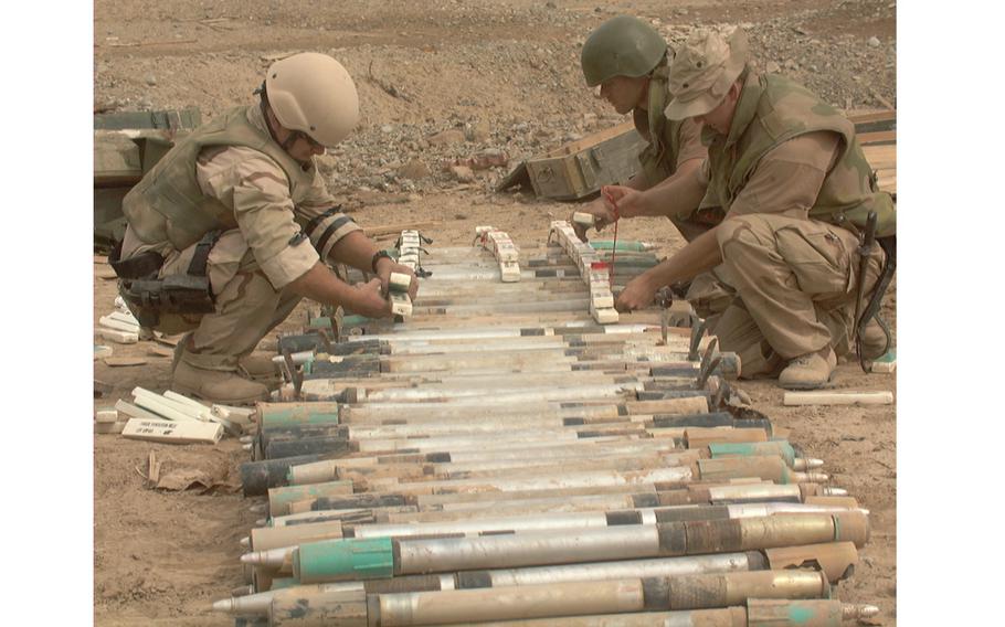 Explosive ordnance experts attach explosives to Soviet rockets 