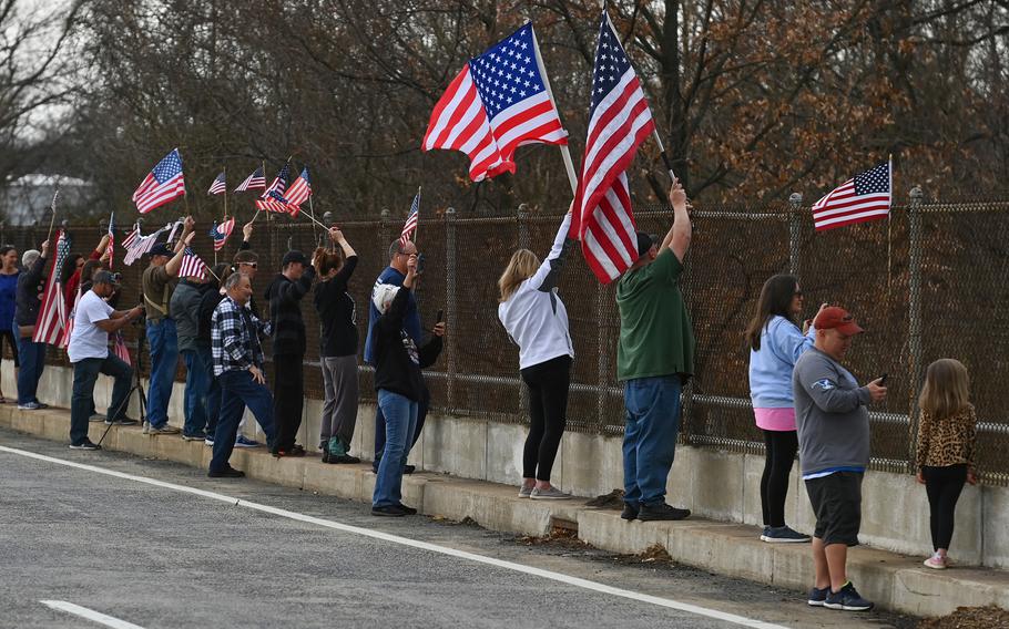 Supporters of the "People's Convoy" cheer and wave flags as it travels east on Interstate 70 on March 7, 2022, in Myersville, Md. 