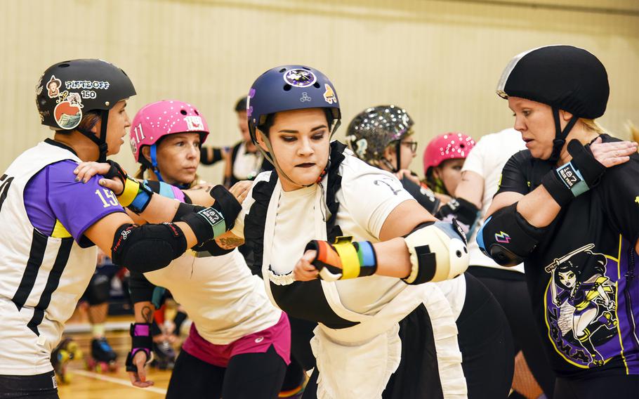 Jay Hudson, center, of the Zama Killer Katanas, blocks opposing players during a “Rocky Horror”-themed roller derby matchup at the Samurai Fitness Center on Yokota Air Base, Japan, Sept. 24, 2023. 