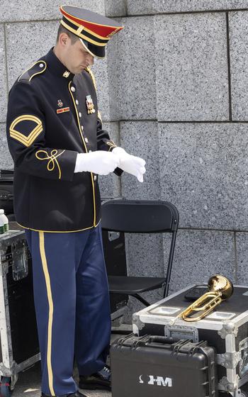 Sgt. 1st Class Kevin Paul of the U.S. Army Band prepares to play Taps at the 20th anniversary celebration of the National World War II Memorial in Washington, D.C., May 25, 2024.