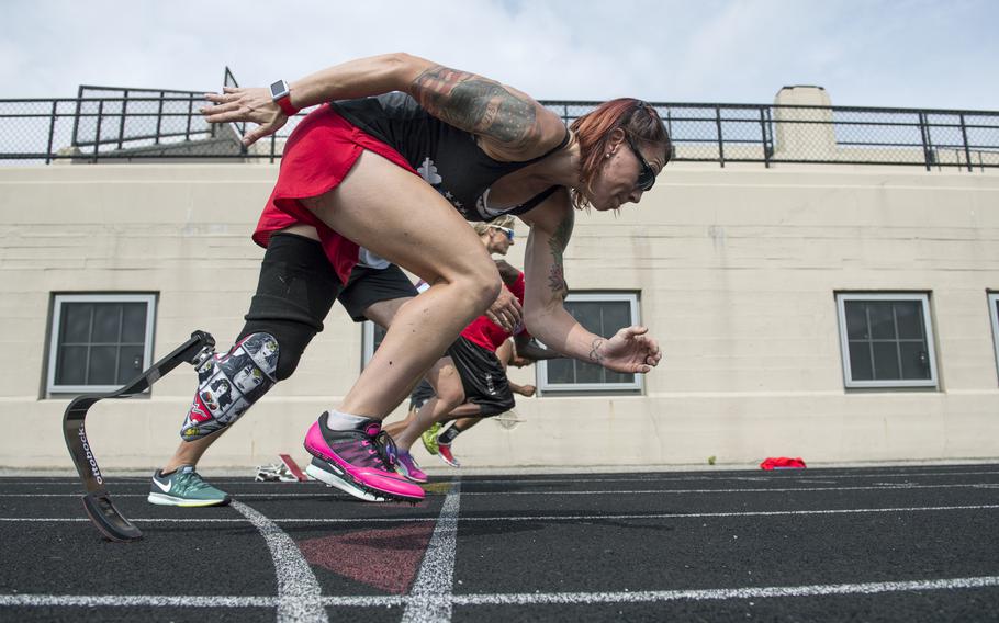 Marine Corps veteran Sarah Rudder teaches starting from blocks during track practice for the 2017 Dept. of Defense Warrior Games in Chicago, Ill. June 30, 2017. In 2016 and 2017, she won 12 gold medals for Team USA at the global Invictus Games for wounded service members. She will compete in the first-ever adaptive division at the 2021 CrossFit Games in Madison, Wis.