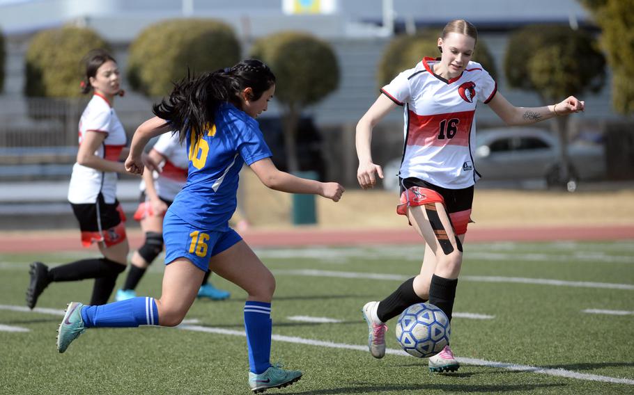 Yuki Arevalo tries to dribble past Alex Bottorff.