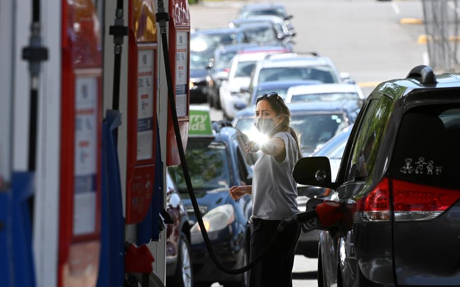 After a cyber hack of the Colonial Pipeline led to gas shortages, people waited in long lines at an Exxon station on May 12, 2021, in Springfield, Va. A major overseas ransomware group shut down last month after a pair of operations by U.S. Cyber Command and a foreign government targeting the criminals’ servers left its leaders too frightened of identification and arrest to stay in business.