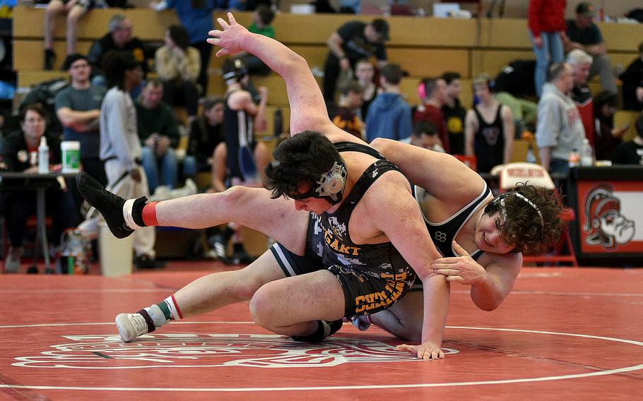 AFNORTH's Nathan Frederickson throws down Stuttgart's Cyrus Montandon during a 285-pound semifinal at a wrestling meet on Jan. 27, 2024, at Kaiserslautern High School in Kaiserslautern, Germany.