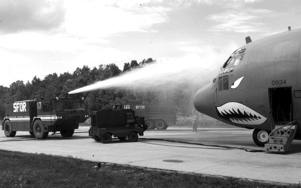 Tuzla Air Base, Bosnia and Herzegovina, July, 1997: A C-130 gets a simulated emergency hose-down by the 401st Expeditionary Air Base Group Fire Department during a mobile airlift techniques exercise. The nose art makes it seem that maybe the plane didn't want a bath ...

Looking for Stars and Stripes’ historic coverage? Subscribe to Stars and Stripes’ historic newspaper archive! We have digitized our 1948-1999 European and Pacific editions, as well as several of our WWII editions and made them available online through https://starsandstripes.newspaperarchive.com/

META TAGS: U.S. Army; Yugoslavia; Bosnia and Herzegovina; IFOR; SFOR; 