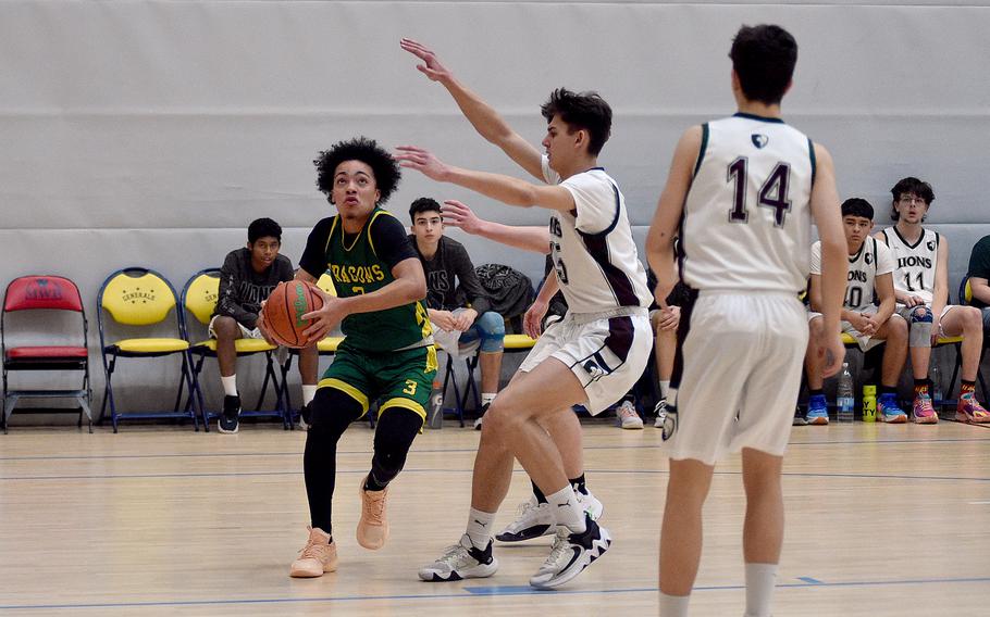 Alconbury senior Julian “JuJu” Brazoban drives toward the basket while AFNORTH’s Nathan Goldsmith defends during pool-play action of the DODEA European basketball championships on Feb. 14, 2024, at the Wiesbaden Sports and Fitness Center on Clay Kaserne in Wiesbaden, Germany.