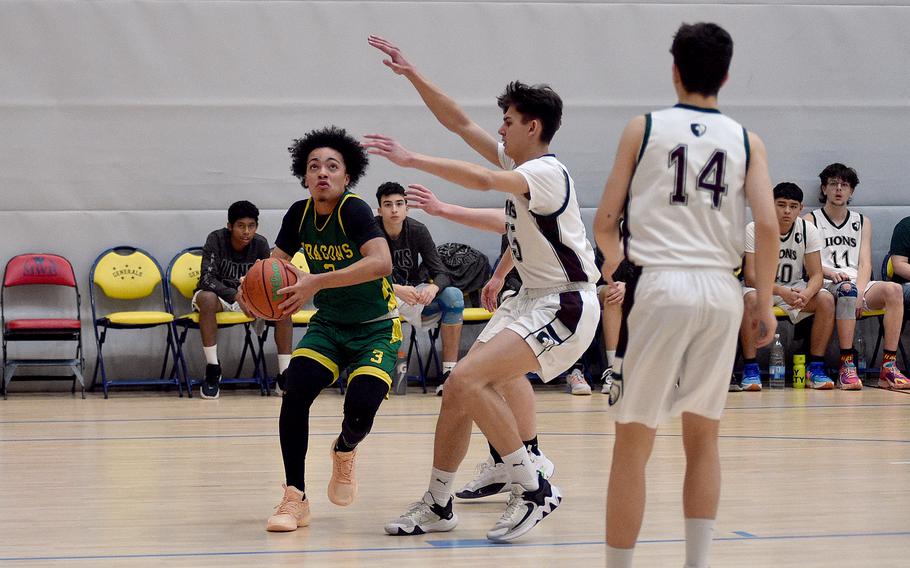 Alconbury senior Julian “JuJu” Brazoban drives toward the basket while AFNORTH’s Nathan Goldsmith defends during pool-play action of the DODEA European basketball championships on Feb. 14, 2024, at the Wiesbaden Sports and Fitness Center on Clay Kaserne in Wiesbaden, Germany.