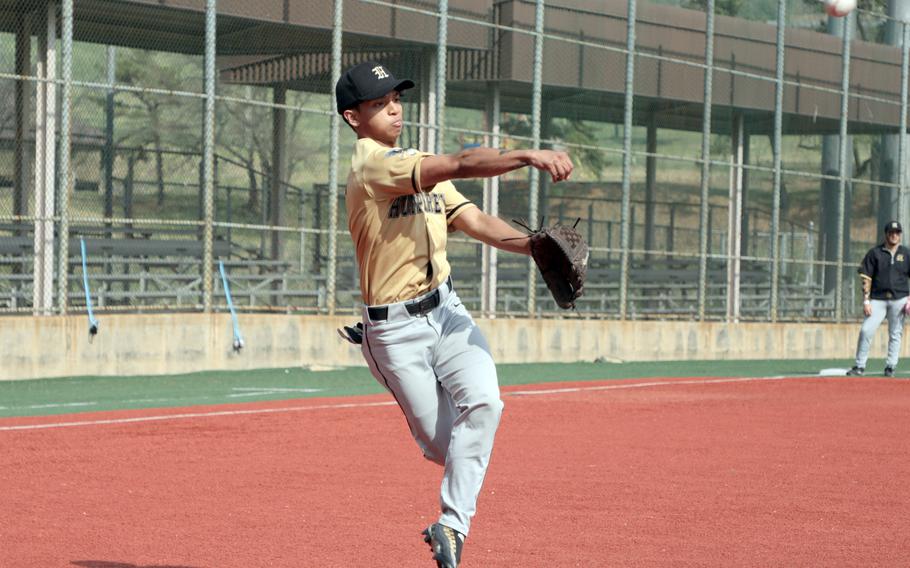 Humphreys second baseman Christian Whiting throws cross body to first base against Osan during Friday's DODEA-Korea baseball game. The Cougars won 5-4.