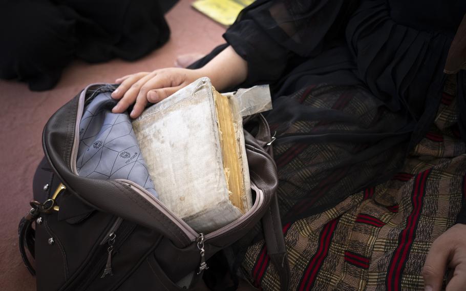 A student has a Quran at hand while secretly attending a class in Kabul. If the police should burst in, the class immediately will assume the guise of religious studies. 