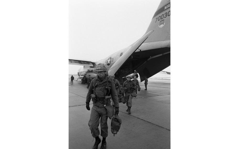 Troops emerge from a C141 StarLifter. In total 63 StarLifters brought 5,000 soldiers here in two days for the climax of the dual-based Army/Air Force exercise. The two services will link up January 29th in Grafenwoehr for Operation Carbide Ice.