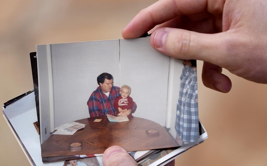 Austin Allen shows a photo of himself with his deceased father, Ted Allen.