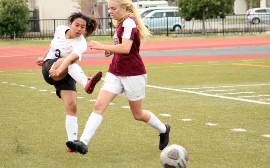 E.J. King's Alyssa Garcia boots the ball past Matthew C. Perry's Cecilia Campbell during Friday's DODEA-Japan soccer match. The Cobras won 2-1.