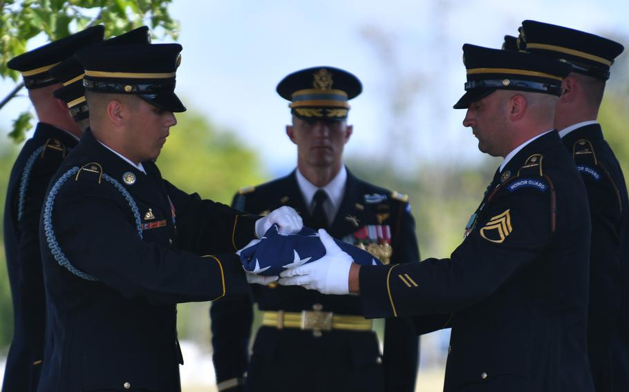 Army honor guards fold the flag during Megellas’ funeral.