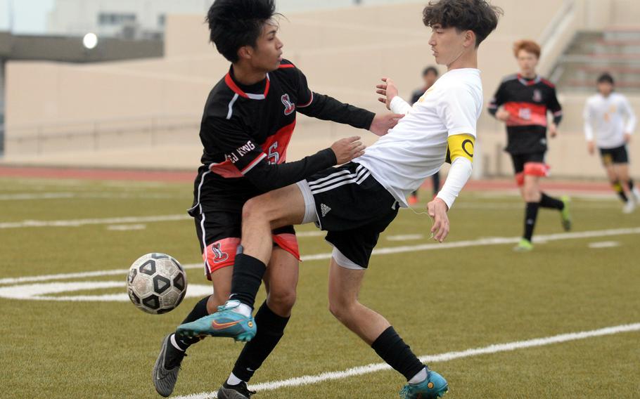 E.J. King's Justin Minimo and Yokota's Senna Solberg battle for the ball during Friday's DODEA-Japan boys soccer match. The teams played to a scoreless draw.
