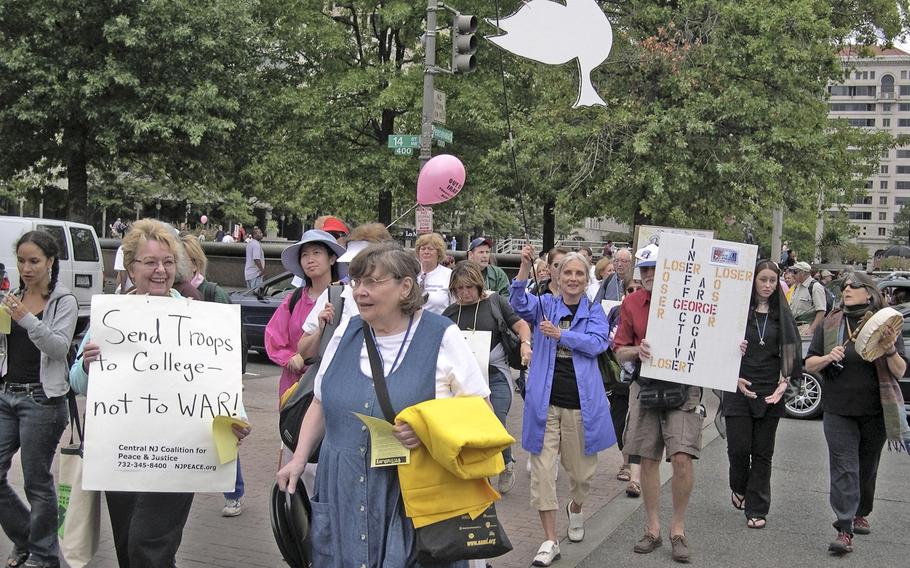 Anti-war demonstrators walk down Pennsylvania Ave. in Washington on their way to the National Mall to gather for a march past the White House.     