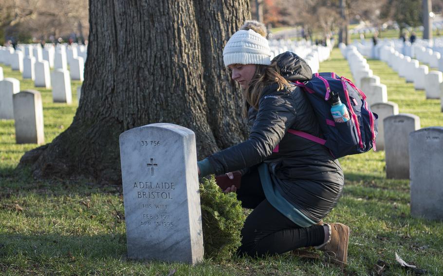 Jaci Horton, of Richmond, Va., lays a wreath at Arlington National Cemetery on Saturday, Dec. 17, 2022.