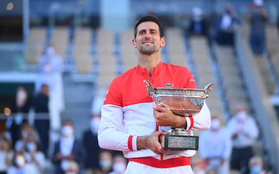 Novak Djokovic enjoys a moment with the trophy after defeating Stefanos Tsitsipas 6-7, 2-6, 6-3, 6-2, 6-4 on Sunday in Paris to win the French Open and claim his 19th Grand Slam title. The victory gives Djokovic a second “career” Grand Slam, meaning he has won each of the sport’s four majors at least twice during his career.