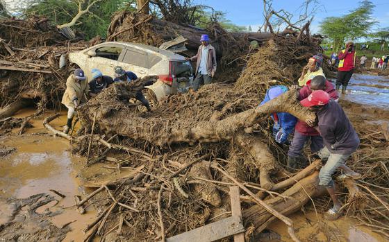 People try to clear the area after a dam burst, in Kamuchiri Village Mai Mahiu, Nakuru County, Kenya, Monday, April 29, 2024. Police in Kenya say at least 40 people have died after a dam collapsed in the country's west.  (AP Photo)