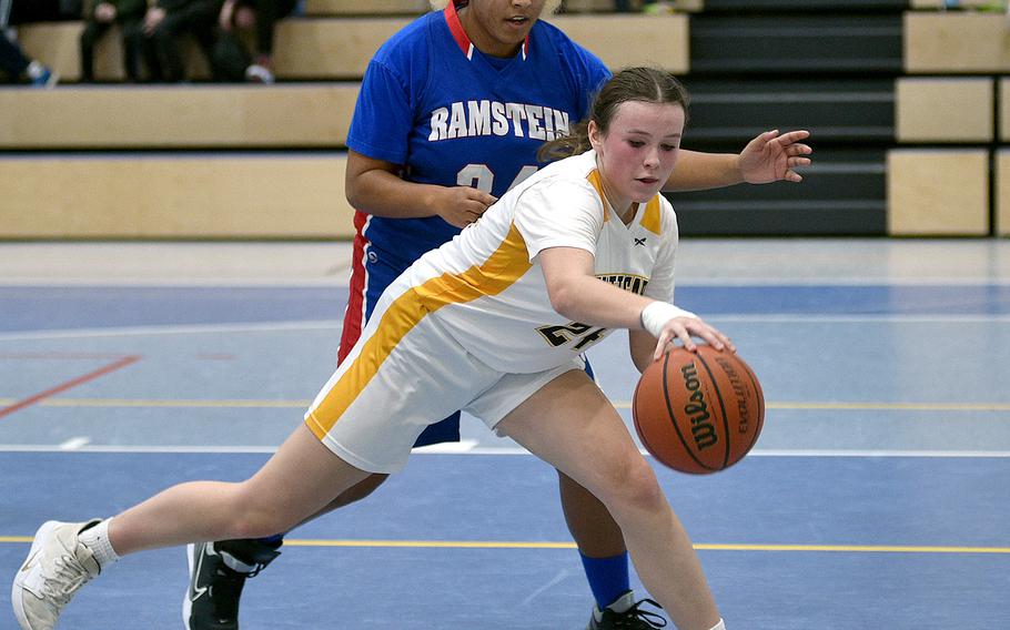 Stuttgart's Ella Kirk and Ramstein's Alysha Edwards battle near the basket during Saturday's game at Ramstein High School on Ramstein Air base, Germany. The Royals defeated the Panthers, 47-35.