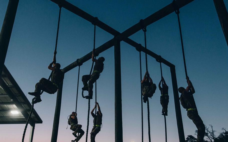 Ranger candidates climb ropes during physical training as part of the Ranger Assessment and Selection Program in April 2023, which qualifies soldiers to join the 75th Ranger Regiment. 