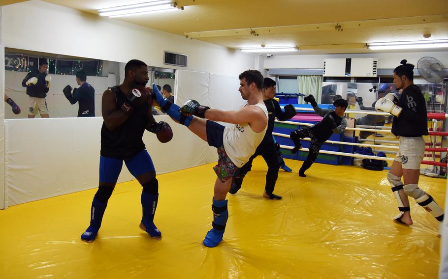Air Force Staff Sgt. Charles Prete, left, a defense courier and MMA fighter stationed at Yokota Air Base, Japan, trains at Alpha Reversal Gym in Tachikawa, April 12, 2023.