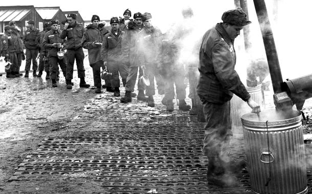 Near Mannheim, West Germany, March, 1962: In a scene familiar to soldiers and veterans everywhere, members of the 2nd Battle Group, 47th Infantry, line up for chow after completing the first leg of a motor march from Augsburg to Berlin. They were to replace the 1st Battle Group, 19th Infantry, in the divided city.

Looking for Stars and Stripes’ historic coverage? Subscribe to Stars and Stripes’ historic newspaper archive! We have digitized our 1948-1999 European and Pacific editions, as well as several of our WWII editions and made them available online through https://starsandstripes.newspaperarchive.com/

META TAGS: U.S. Army; 47th Inf. Div.; food; military life; 

https://www.stripes.com/migration/2021-05-20/Chow-line-1962-1543751.html