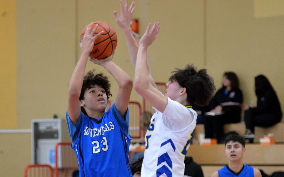 Hohenfels’ Tavon Washington attempts a shot over Sigonella’s Andrew Martin in a D-III game on opening day of the DODEA-Europe basketball finals in Baumholder, Germany, Feb. 15, 2023. The Tigers beat the Jaguars 40-27.