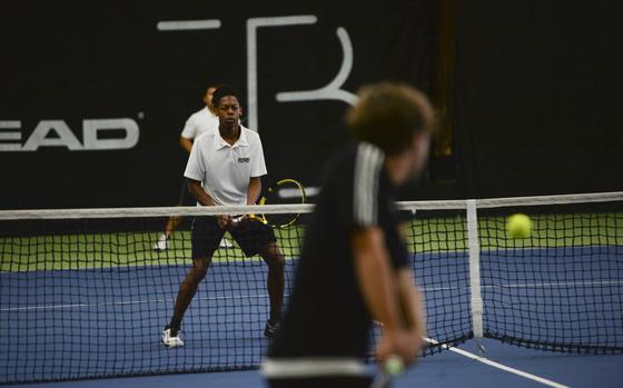 Bahrain's Carson Owens stands ready just behind the net, anticipating the ball's trajectory, as Stuttgart's Zachary Call hits at the DODEA European tennis championships at T2 Sports Health Club in Wiesbaden, Germany, on Oct. 21, 2023.