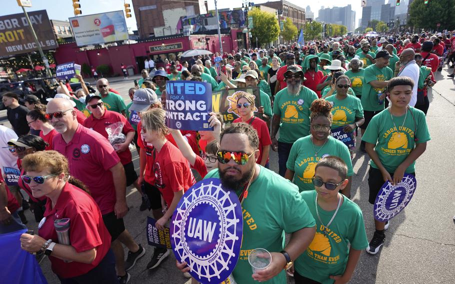 United Auto Workers members walk in the Labor Day parade in Detroit on Sept. 4, 2023. The union is threatening to strike any automaker that hasn’t reached an agreement by the time contracts expire on Sept. 14. 