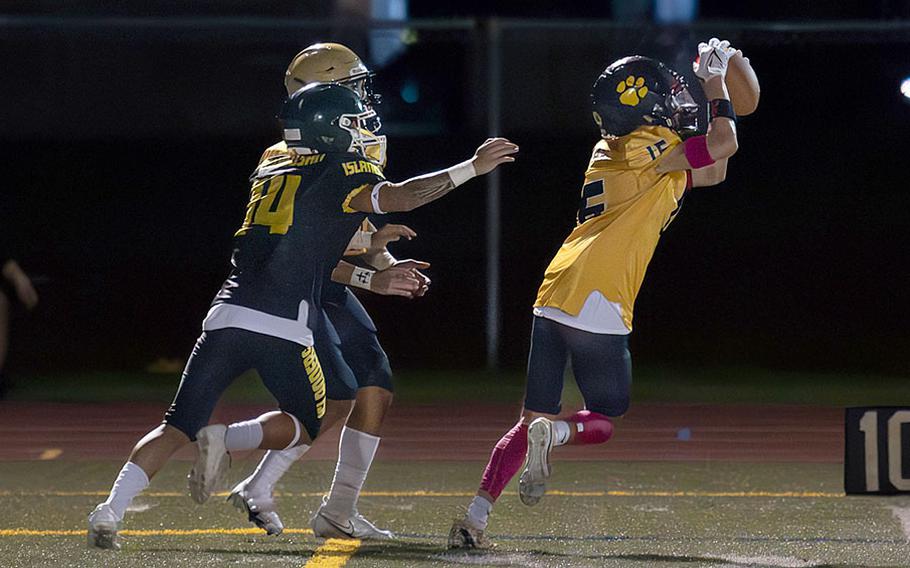 Guam High's Braden Flynn snags the first of his two interceptions.