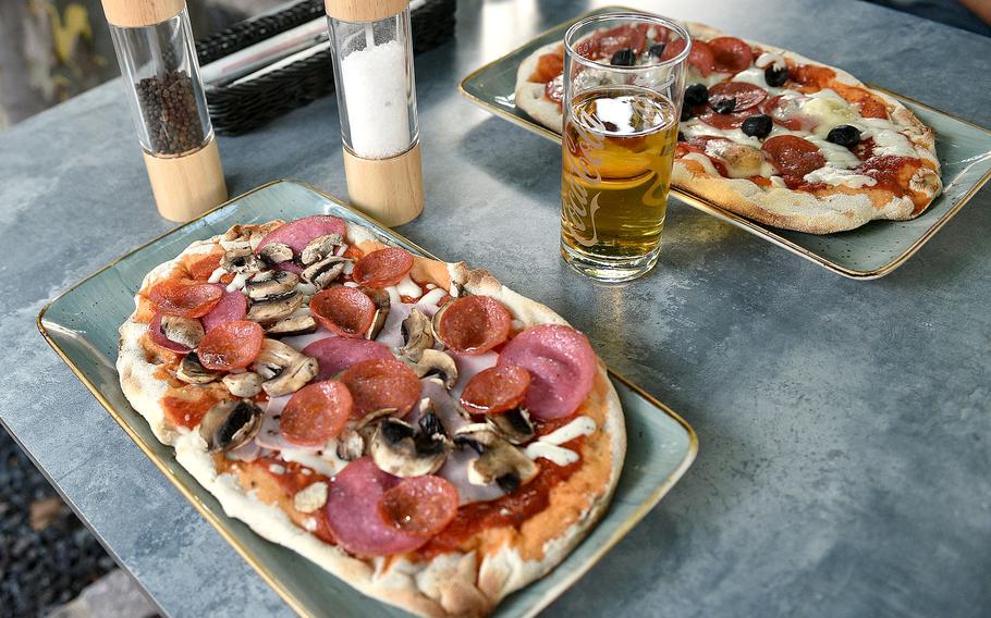 Two pinsas with a variety of toppings. They are similar to pizzas.