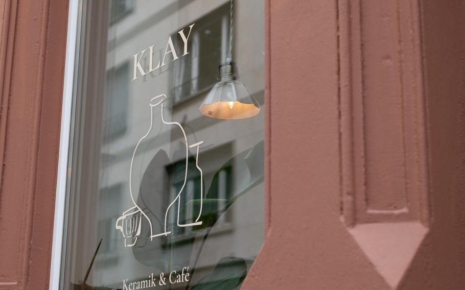 The exterior window of a cafe bears the establishement’s name.