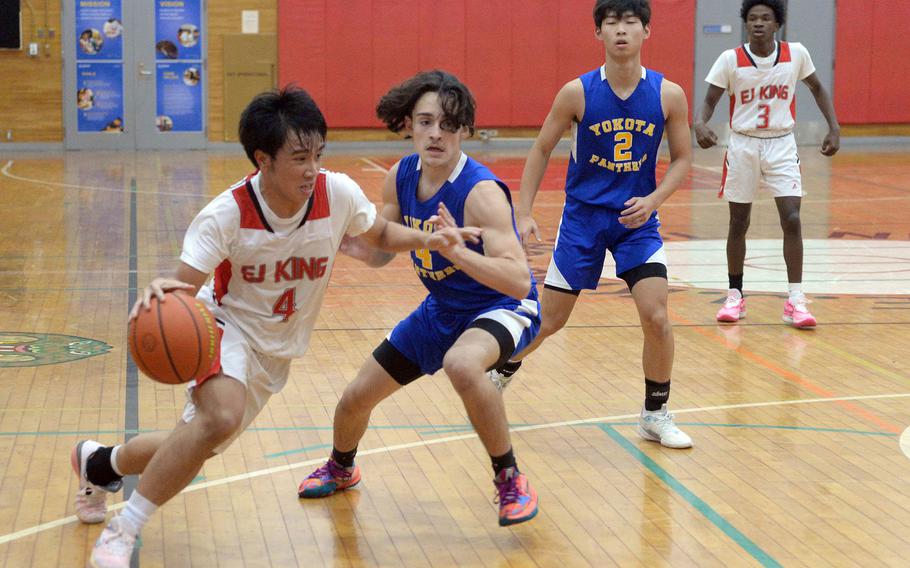 E.J. King's Shan Casimiro drives against Yokota's Rodrigo Negron during Friday's DODEA-Japan boys basketball game. The Panthers won 72-70.