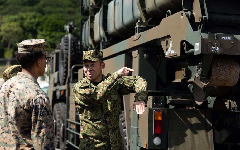 A Japanese soldier briefs U.S. troops on the Type 12 surface-to-ship missiles at Camp Ishigaki on Ishigaki, an island in Okinawa prefecture, Oct. 20, 2023.