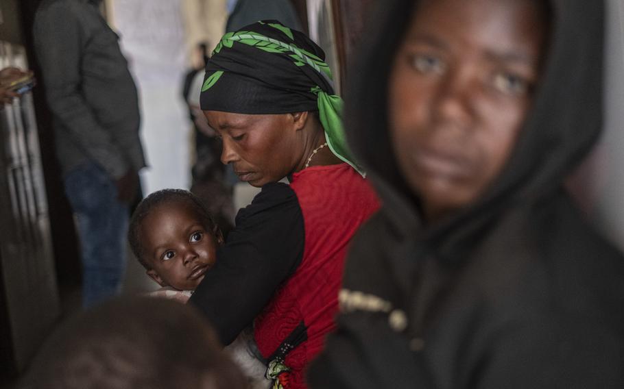 Individuals listen to a broadcast in the Congo.