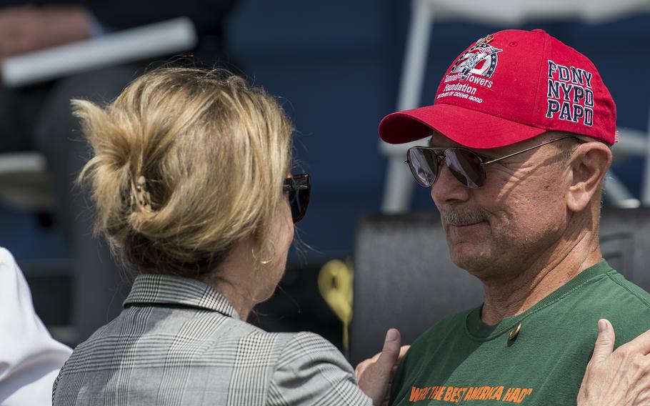 Rep. Madeleine Dean, D-Pa., pats Army veteran Bill Trump on the shoulders after affixing a commemorative Vietnam War pin on his shirt on Thursday, May 11, 2023, during the opening ceremony of a three-day event to honor Vietnam War veterans in Washington, D.C.