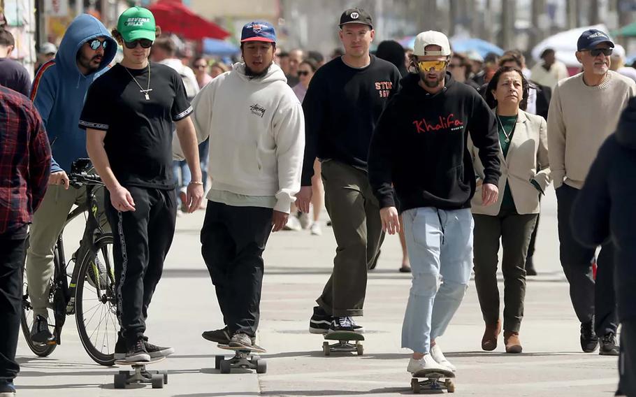 From left, Lawrence Doherty, Daniel Galan, Ryan Fonseca and Braden Walker skateboard on the Venice Beach boardwalk in Los Angeles for a bonus segment of the “California Double.”